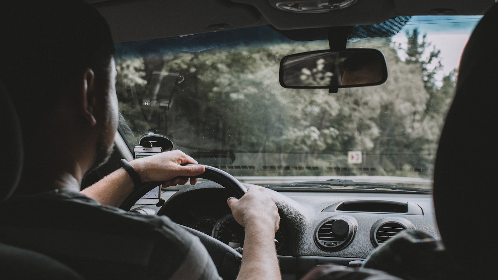 person driving car during daytime auto